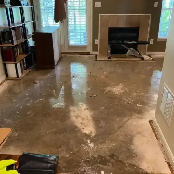 Wet concrete floor in a living room after the flooring was pulled up